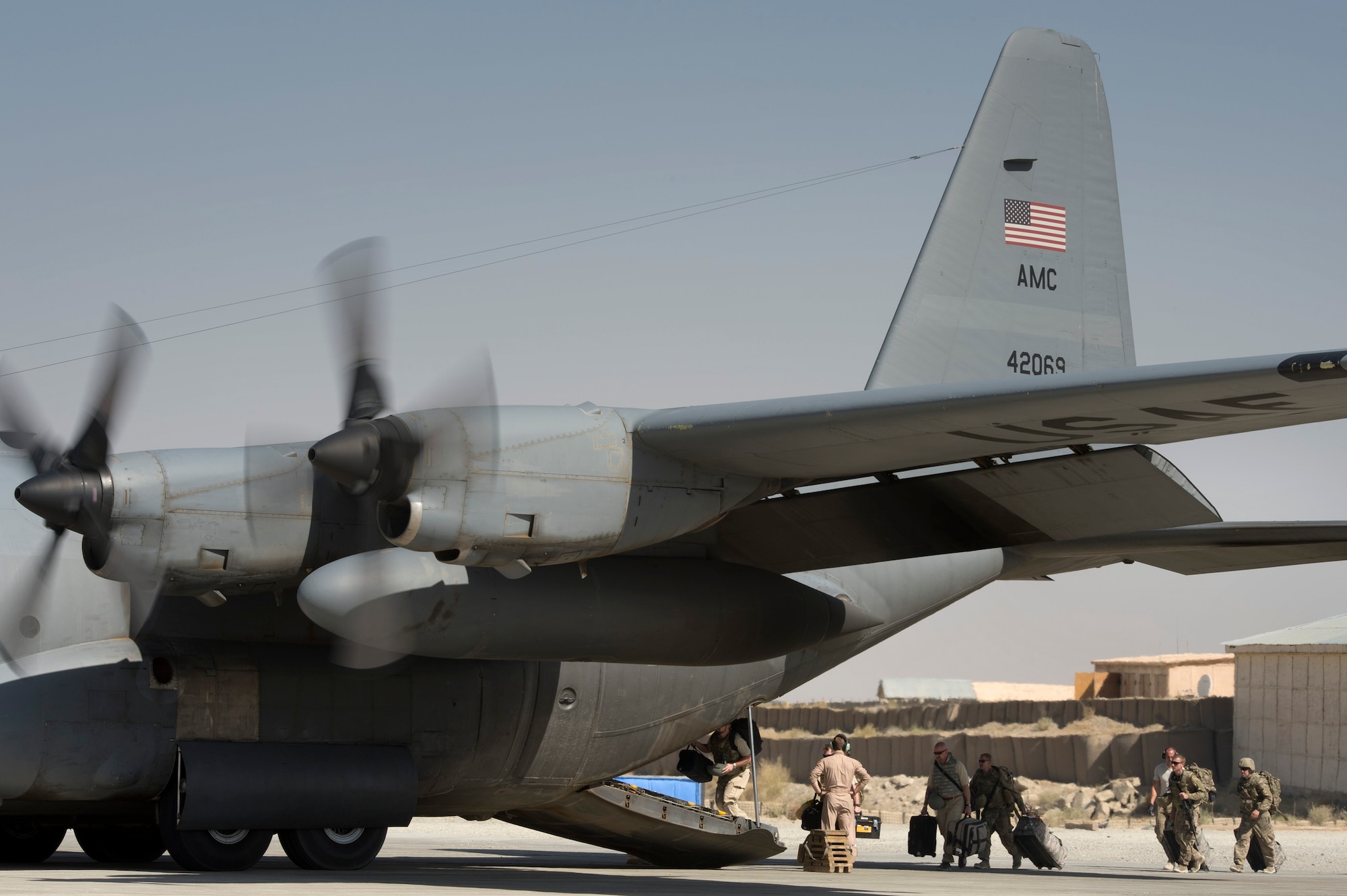 A number of final Department of Defense and military passengers board a 774th Expeditionary Airlift Squadron C-130 Hercules at Forward Operating Base Sharana, Paktika province, Afghanistan, Sept. 28, 2013. This mission marked a retrograde milestone as the 774th EAS transported the last cargo from FOB Sharana before the base is transferred to the Afghan Ministry of Defense. (USAF Photo/Master Sgt. Ben Bloker)