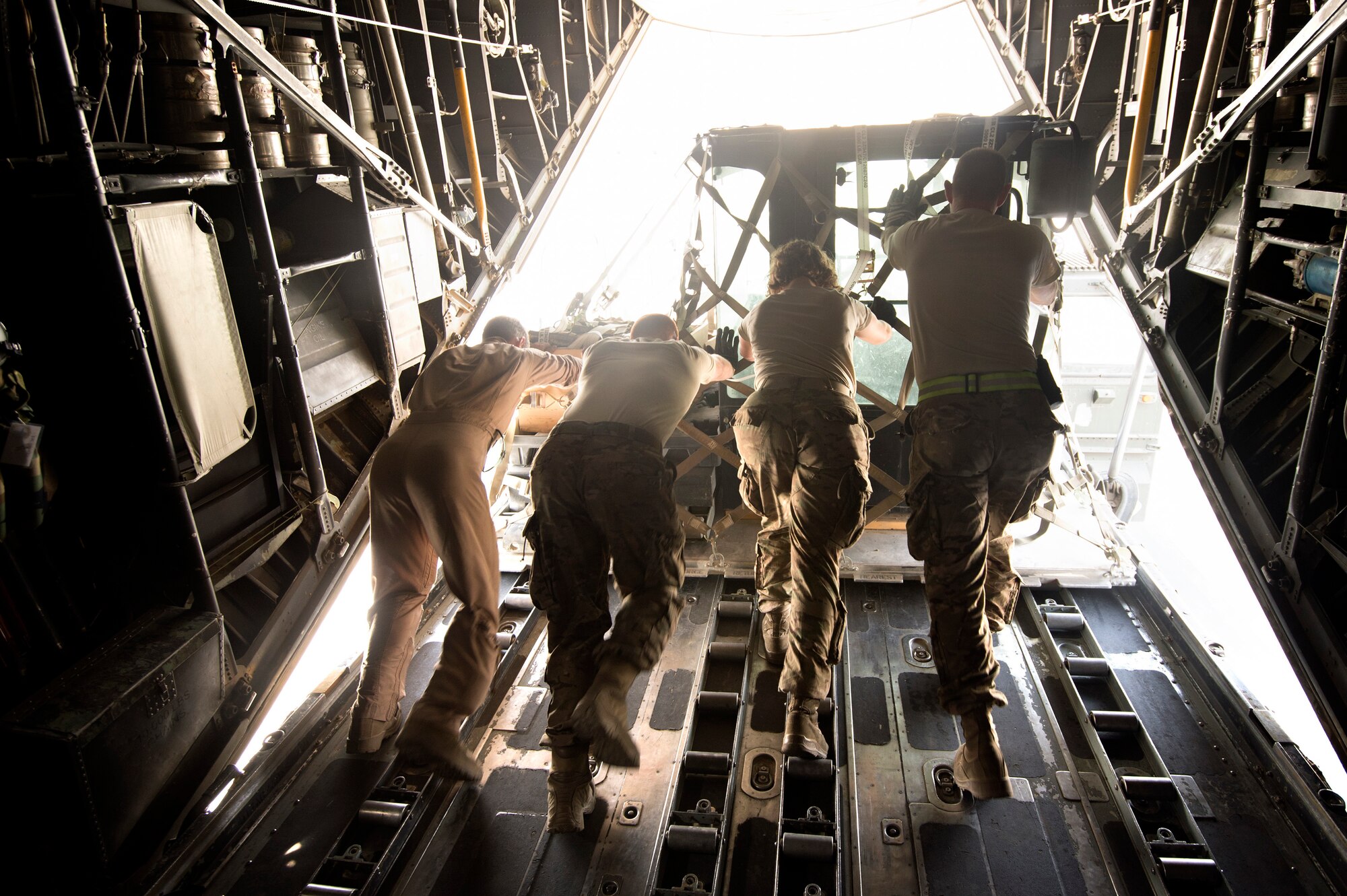 Senior Airman Zac Sidders, 774th Expeditionary Airlift Squadron loadmaster, assists aerial porters from the 455th Expeditionary Aerial Port Squadron pushing cargo off a C-130 Hercules at Bagram Air Field, Afghanistan, Sept. 28, 2013. This mission marked a retrograde milestone as the 774th EAS transported the last cargo from Forward Operating Base Sharana, Paktika province, Afghanistan, before the base is transferred to the Afghan Ministry of Defense. Sidders, a Peoria, Ill., native, is deployed from the Wyoming Air National Guard. (USAF Photo/Master Sgt. Ben Bloker)