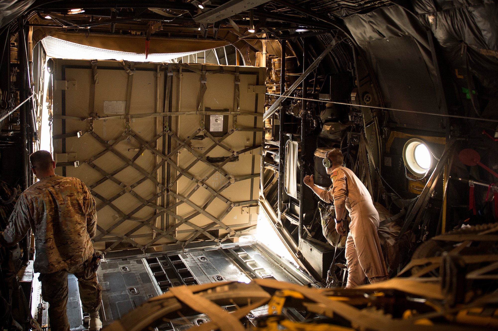 Senior Airman Zac Sidders, 774th Expeditionary Airlift Squadron C-130 Hercules loadmaster, marshals in a "tricon" shipping container at Forward Operating Base Sharana, Paktika province, Afghanistan, Sept. 28, 2013. This mission marked a retrograde milestone as the 774th EAS transported the last cargo from FOB Sharana before the base is transferred to the Afghan Ministry of Defense. Sidders, a Peoria, Ill., native, is deployed from the Wyoming Air National Guard. (USAF Photo/Master Sgt. Ben Bloker)