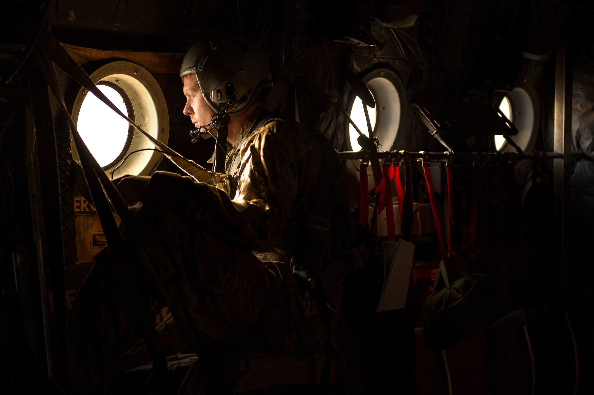 Staff Sgt. Nick Sanborn, 774th Expeditionary Airlift Squadron C-130 Hercules loadmaster, scans for threats during a retrograde mission to Forward Operating Base Sharana, Paktika province, Afghanistan, Sept. 28, 2013. This mission marked a retrograde milestone as the 774th EAS transported the last cargo from FOB Sharana before the base is transferred to the Afghan Ministry of Defense. Sanborn, a Vacaville, Calif., native, is deployed from Little Rock Air Force Base, Ark. (USAF Photo/Master Sgt. Ben Bloker)