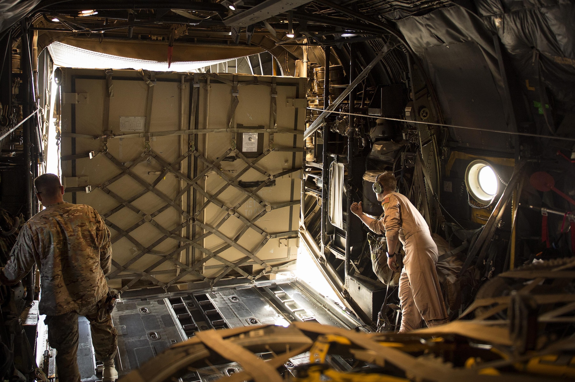 Senior Airman Zac Sidders, 774th Expeditionary Airlift Squadron C-130 Hercules loadmaster, marshals in a "tricon" shipping container at Forward Operating Base Sharana, Paktika province, Afghanistan, Sept. 28, 2013. This mission marked a retrograde milestone as the 774th EAS transported the last cargo from FOB Sharana before the base is transferred to the Afghan Ministry of Defense. Sidders, a Peoria, Ill., native, is deployed from the Wyoming Air National Guard. 