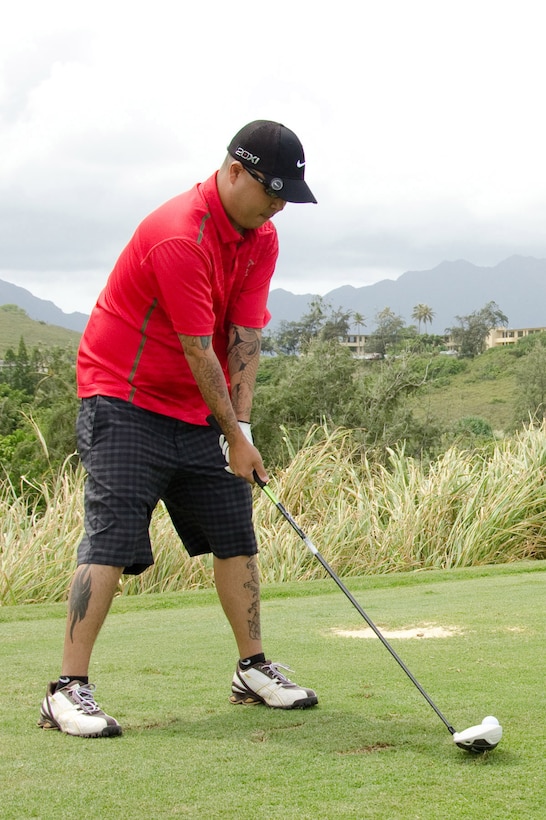 Shaun Chijimatsu, assistant manager at Kahuna's Sports Bar and Grill, takes his turn during the Commander's Cup Golf Classic at the Kaneohe Klipper Golf Course, Sept. 27, 2013. (U.S. Marine Corps photo by Kristen Wong)