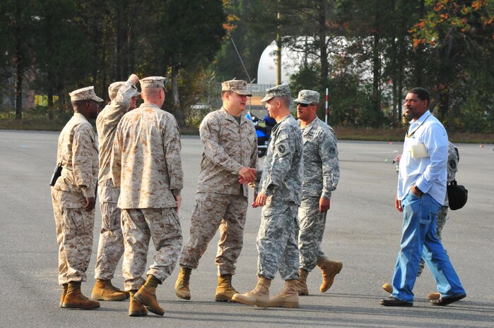 Marines from Marine Corps Base Quantico greet members of the Joint Task Force- National Capital Region at Camp Upsher on Oct. 3, 2013. The interservice officers toured the camp to see its limitations and capabilities.