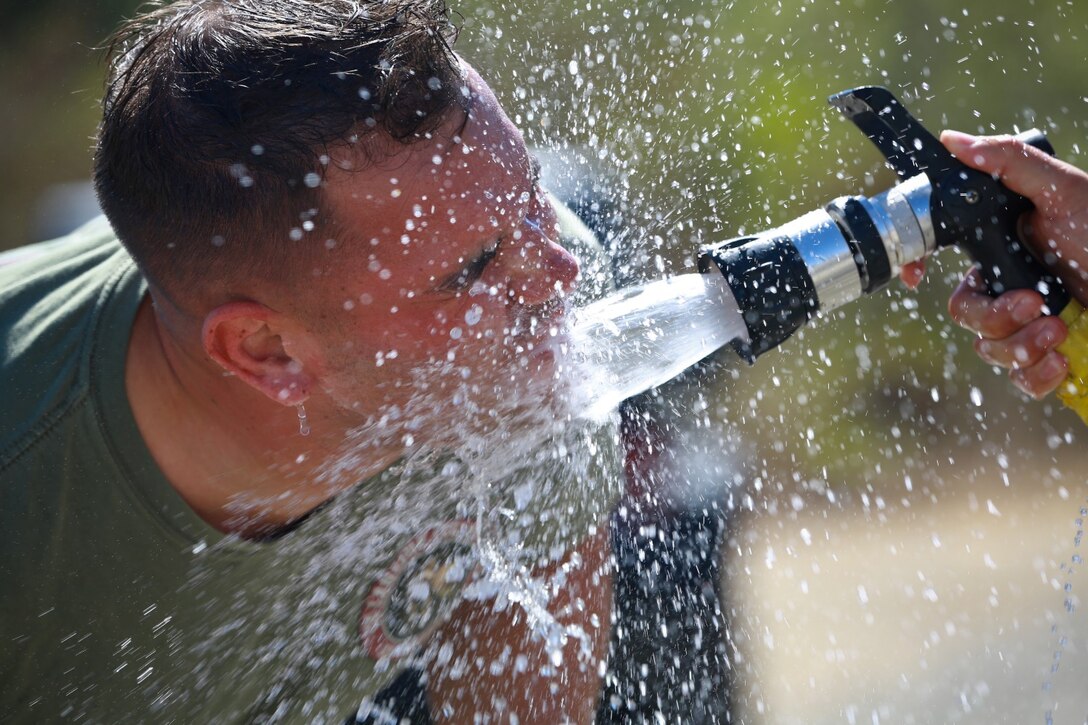 Staff Sgt. Randy Coole, 1st Platoon sergeant, Delta Company, 1st Battalion, 1st Marine Regiment, rinses his face after enduring a nonlethal weapons training course here where he was sprayed with pepper spray, Oct. 1, 2013. The Marines with Delta Company are preparing for a deployment to the Middle East where they’ll provide embassy security. Coole is a native of Oakley, Mich.