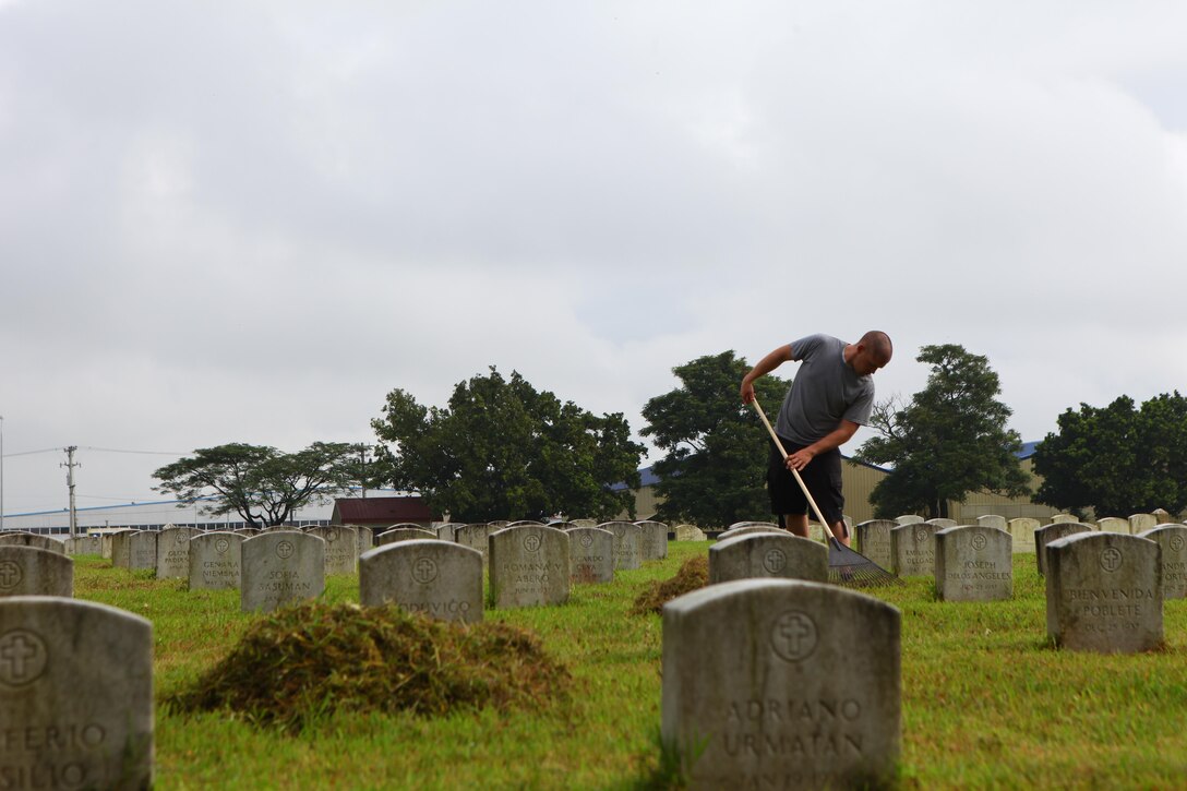 Lance Cpl. David V. Whitehead volunteers his free time to rake leaves and grass at Clark Veterans Cemetery, Clark Air Field, Pampanga, Republic of the Philippines, Sept. 28. "It is important to demonstrate our good faith to the community, our Filipino family and these fallen service members," said Navy Lt. Stephen F. Brown, chaplain for 3d Marine Expeditionary Brigade, III Marine Expeditionary Force. "Often we can get stuck in our operations and training and forget to engage in demonstrating the generous nature that we are capable of giving." Whitehead is a landing support specialist with 3d MEB and is in the Philippines conducting Amphibious Landing Exercise 2014. PHIBLEX 14, now in its 30th iteration, demonstrates the U.S. and Republic of the Philippines' commitment to mutual security and their long-time partnership. (U.S. Marine Corps photo by Lance Cpl. Jose D. Lujano)