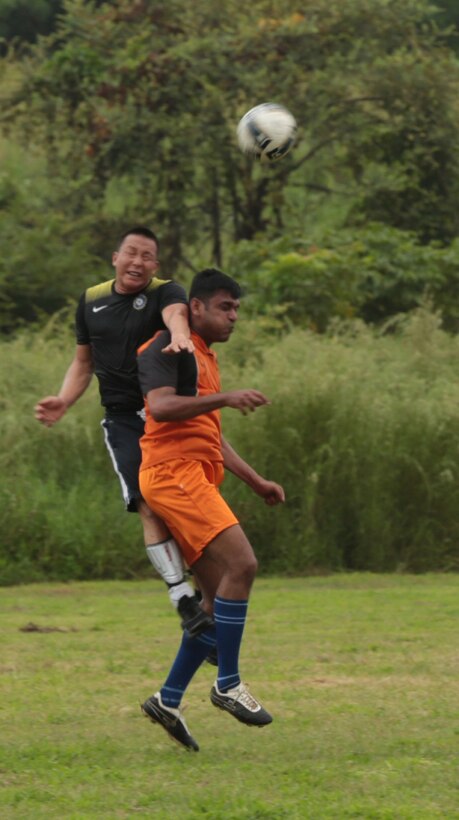 Lance Cpl. Richard G. Hall, right defense and Infantry Automatic Rifle Gunner, with Bravo Company, Battalion Landing Team 1/4, 13th Marine Expeditionary Unit and Monroe, Mich. native, deflects the ball from Indian Navy Sailors during a soccer match in the State of Goa, India as part of Exercise Shatrujeet 2013, Oct.3, 2013. The purpose of the exercise was to enhance U.S.-India military-to-military relations, hone individual and small-unit skills and exchange knowledge. Marines and Sailors with 13th MEU will deploy for several months in support of theater requirements of Geographic Combatant Commanders. (Official .U.S Marine Corps photo by Sgt. Christopher O'Quin/Released)