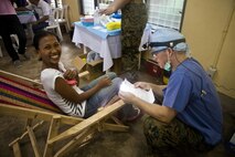 U.S. Navy Lt. Seth Perrins, dentist, 3d Medical Battalion, 3d Marine Expeditionary Brigade, III Marine Expeditionary Force, provides dental care to a Legazpi citizen during a cooperative health engagement at Bigaa Elementary School, Legazpi City, Albay, Republic of the Philippines, Sept. 26, 2013 as part of Amphibious Landing Exercise 2014 (PHIBLEX 14).  Members of the Armed Forces of the Philippines, and U.S. Marines and sailors from 3d MEB are conducting humanitarian and civic assistance projects, which include engineering projects and cooperative health engagements, in Legazpi City as part of PHIBLEX 14.  Humanitarian and civic assistance projects enable Philippine and U.S. military members to learn about each other's culture, train together, and improve interoperability while providing services to areas with identified need.  (U.S. Marine Corps photo by Lance Cpl. Katelyn Hunter/Released)