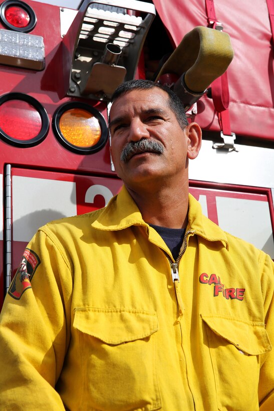 Capt. Mark Lopez leans against his fire engine on Camp Pendleton Oct. 7.