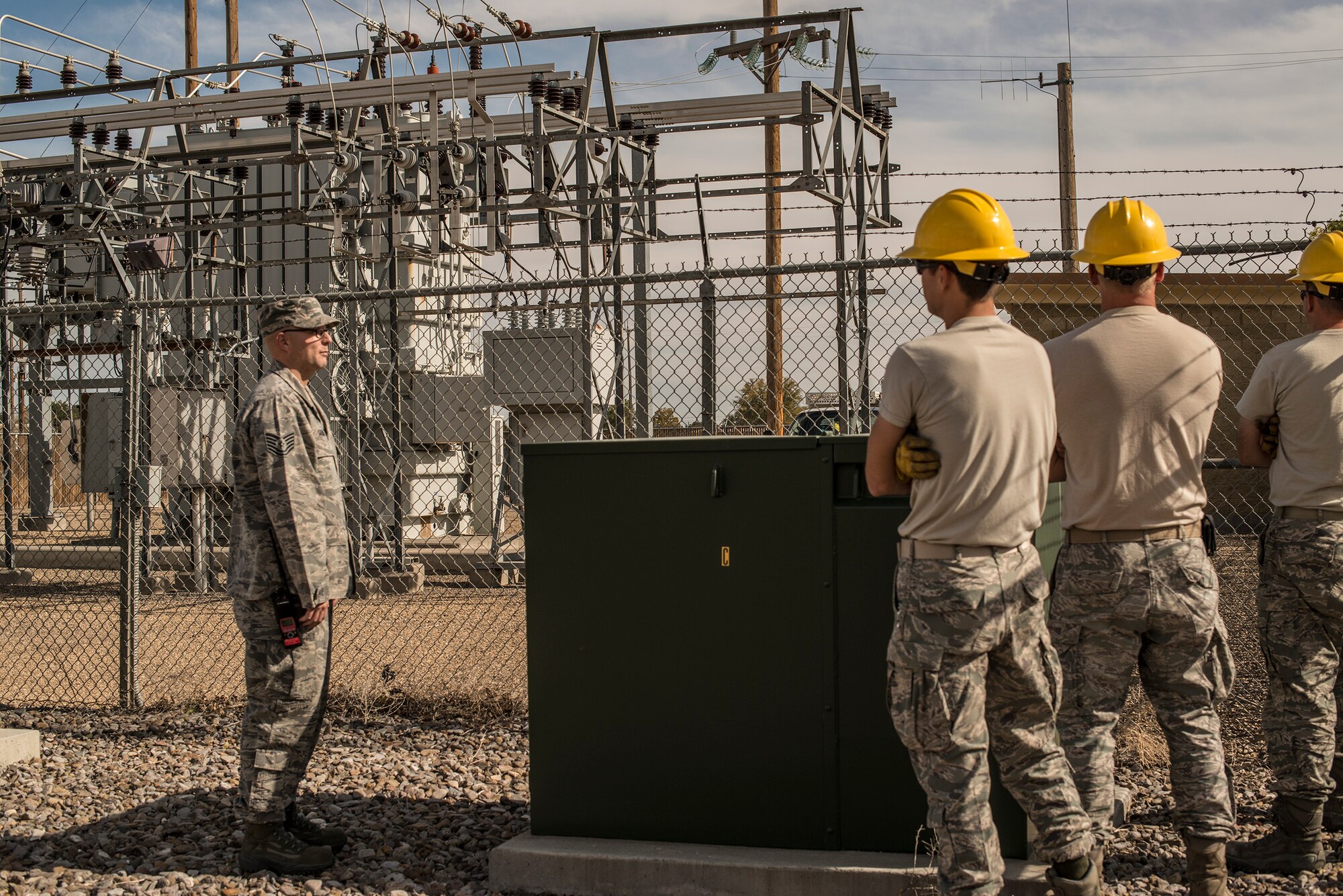 U.S. Air Force Tech. Sgt. Justin Gardiner, 366th Civil Engineer Squadron electrical systems technician, briefs a crew of CES Airmen, as they work with Idaho Power Company to switch circuits and restore power to Mountain Home Air Force Base, Idaho, Oct. 7, 2013. The base was without power for a few hours after the main circuit bringing power to the base malfunctioned. (U.S. Air Force photo by Master Sgt. Kevin Wallace/RELEASED)