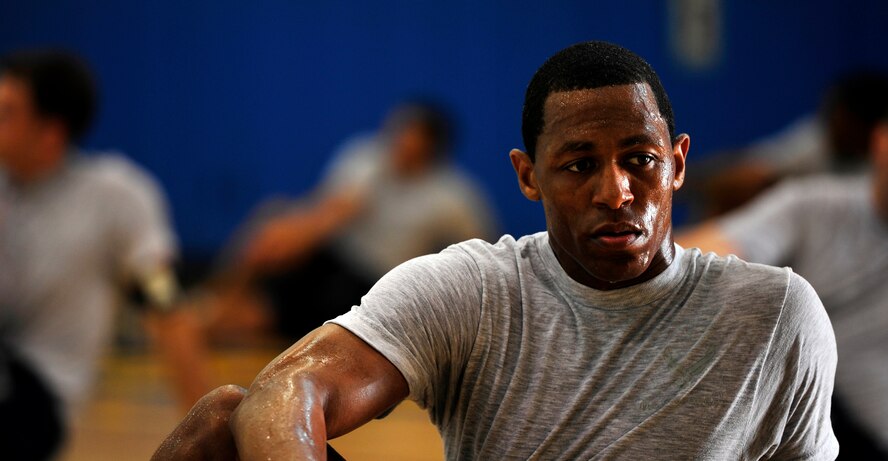 Master Sgt. Jesse Horton, 8th Security Forces Squadron command support staff member, stretches with his squadron at Kunsan Air Base, Republic of Korea, Aug. 28, 2013. Horton hopes to inspire other Airmen through his running just as he was motivated to complete a 50K ultra-marathon.(U.S. Air Force photo by Senior Airman Armando A. Schwier-Morales/Released)
