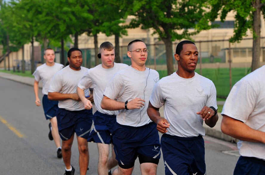 Master Sgt. Jesse Horton, 8th Security Forces Squadron command support staff member, right, runs with his squadron at Kunsan Air Base, Republic of Korea, Aug. 28, 2013. Horton ran a 50K ultra-marathon, placing 96th overall out of 1,300 competitors. (U.S. Air Force photo by Senior Airman Armando A. Schwier-Morales/Released)