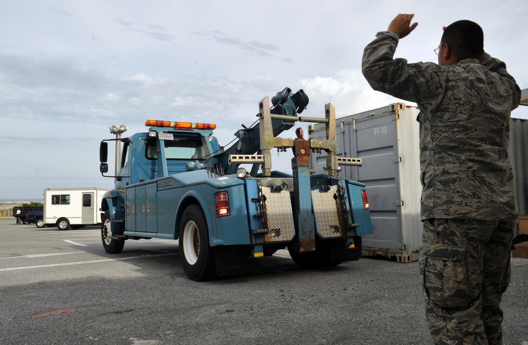 U.S. Air Force Airman 1st Class Antonio Salgado, 18th Logistics Readiness Squadron vehicle operator, guides a wrecking vehicle during Typhoon Fitow preparation at Kadena Air Base, Japan, Oct. 4, 2013. Members from the 18th LRS prepared for the typhoon by moving government operated vehicles to safer locations. (U.S. Air Force photo by Naoto Anazawa)
 
