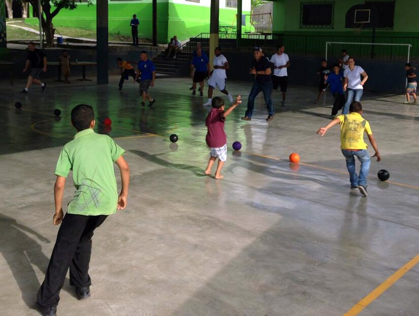Members of Joint Task Force-Bravo's Army Forces Battalion play dodgeball with children from the Horizontes al Futuro orphanage, Oct. 6, 2013.  The ARFOR members brought sandwiches and treats for the children, then spent the afternoon visiting and playing games with them.  (Courtesy photo)