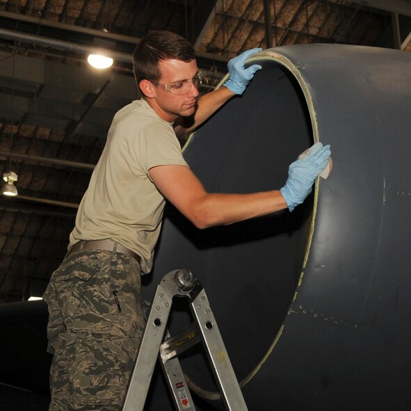 Airman 1st Class William Earnheart, 2nd Maintenance Squadron aircraft structural maintenance journeyman, sands part of a B-52H Stratofortress on Barksdale Air Force Base, La., Oct. 7, 2013. Each aircraft is scheduled for maintenance checks periodically, including paint touch-ups to extend the longevity of their use. (U.S. Air Force photo/ Senior Airman Kristin High)