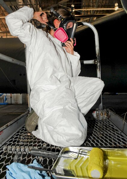 Airman 1st Class Shelby Pearson, 2nd Maintenance Squadron aircraft structural maintenance journeyman, tightens her protective mask before priming a B-52H Stratofortress on Barksdale Air Force Base, La., Oct. 7, 2013. Airmen wear protective gear due to the toxins in the primer they use on the aircraft. (U.S. Air Force photo/ Senior Airman Kristin High)