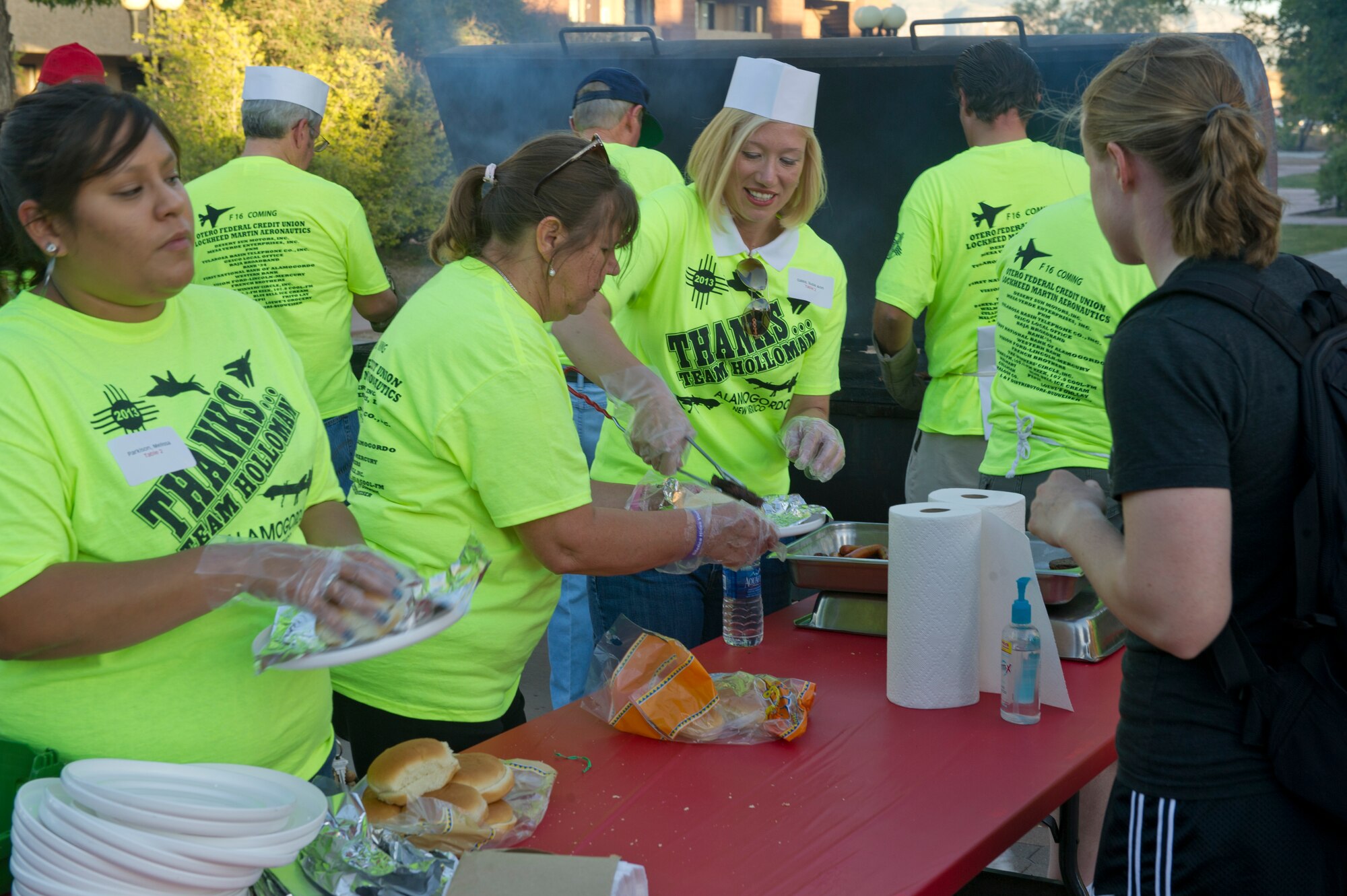 Mayor of Alamogordo Susie Galea, located in the center, serving hamburgers and hotdogs at this year’s Thanks Team Holloman celebration held in the dormitory courtyards at Holloman Air Force Base N.M., Oct. 4. This annual event is hosted by the Committee of 50 and local businesses from Alamogordo to show their appreciation for all members of Team Holloman. (U.S. Air Force photo by Airman 1st Class Chase Cannon/Released)