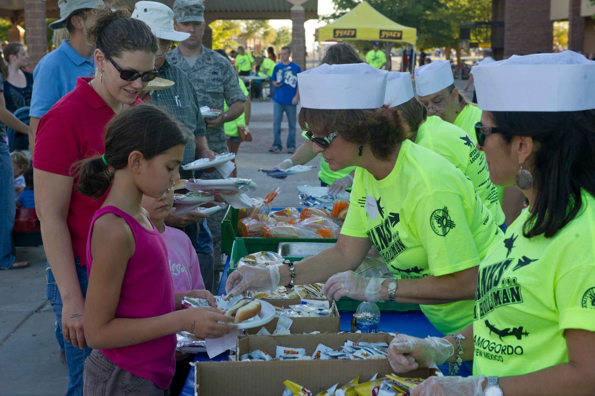 Volunteers from the Tularosa Basin community serve food to members of Team Holloman in the dormitory courtyard during this year’s Thanks Team Holloman celebration at Holloman Air Force Base, N.M., Oct. 4. This annual event is hosted by the Committee of 50 and local businesses from Alamogordo to show their appreciation for all members of Team Holloman. (U.S. Air Force photo by Airman 1st Class Chase Cannon/Released)