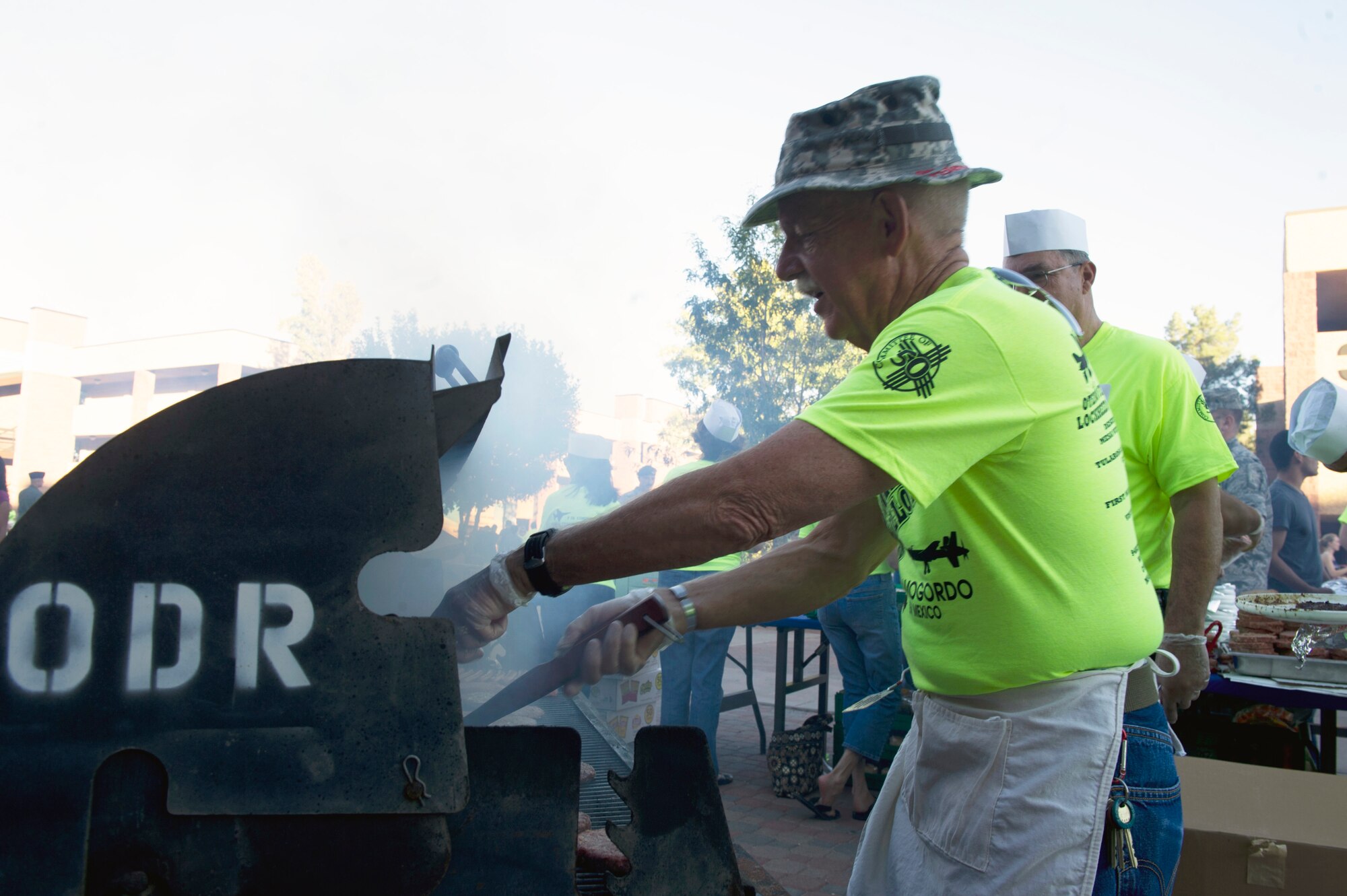 Dwight Harp, 49th Wing Force Support Squadron Marketing commercial sponsorship coordinator, grills hamburgers and hot dogs for this year’s Thanks Team Holloman celebration in the dormitory courtyard at Holloman Air Force Base, N.M., Oct. 4. This annual event is hosted by the Committee of 50 and local businesses from Alamogordo to show their appreciation for all members of Team Holloman. (U.S. Air Force photo by Airman 1st Class Chase Cannon/Released)