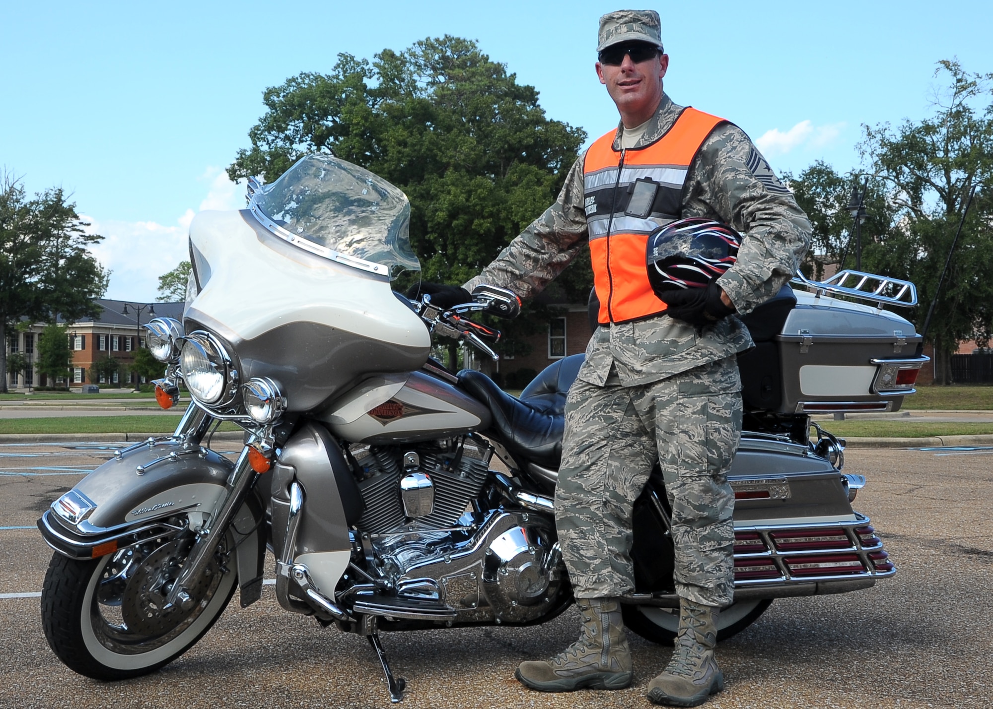 Chief Master Sergeant Vance Kondon, 14th Flying Training Wing Command Chief, stands by his Harley Davidson motorcycle Sep. 24 on Columbus AFB. Kondon wears all the proper personal protective equipment including pants, long sleeve shirt, reflective vest, over-the-ankle shoes, gloves and a Department of Transportation approved helmet. (U.S. Air Force Photo/Amn Daniel Lile)

