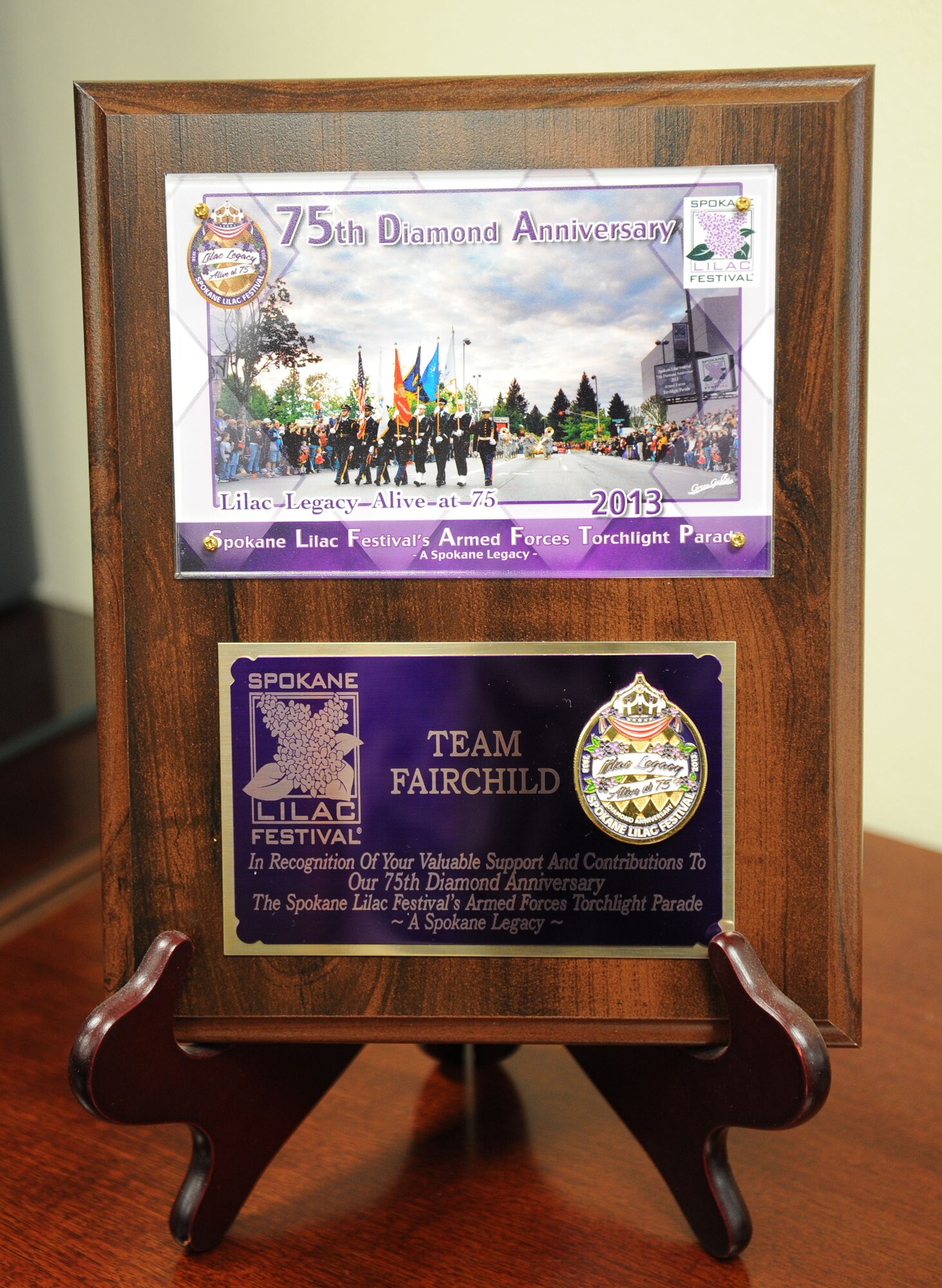 Col. Brian Newberry, 92nd Air Refueling Wing commander, and Team Fairchild were presented the Spokane Lilac Festival Partner Award at Fairchild Air Force Base, Wash., Sept. 25, 2013. (U.S. Air Force photo by Airman 1st Class Janelle Patiño/Released)