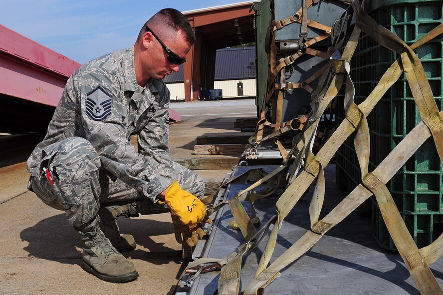 U.S. Air Force Master Sgt. Rodger Boles, 4th Aircraft Maintenance Squadron support section chief, secures cargo to a pallet during a training class at Seymour Johnson Air Force Base, N.C., Oct. 3, 2013. Students received hands-on training breaking down and building up pallets in preparation for operational readiness exercise CORONET WARRIOR 13-04. (U.S. Air Force photo by Airman 1st Class John Nieves Camacho)