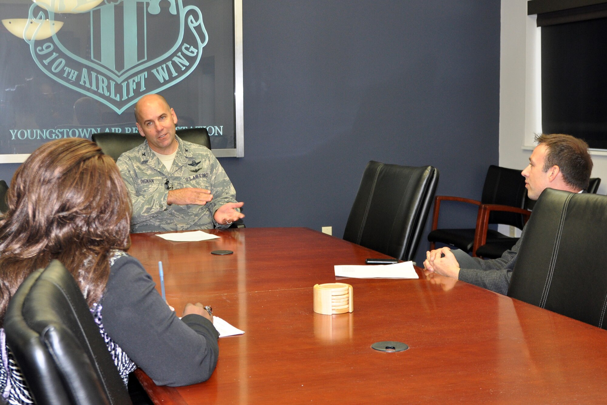 YOUNGSTOWN AIR RESERVE STATION, Ohio - Air Force Reserve Col. James Dignan, 910th Airlift Wing commander, talks with reporters from Youngstown-area television media outlets regarding Department of Defense civilians returning to work here, October 7, 2013. Approximately 400 YARS employees got back on the job as a result of the Pay Our Military Act that allowed the return to work despite the ongoing government shutdown and federal employee furloughs. U.S. Air Force photo by Master Sgt. Bob Barko Jr.     