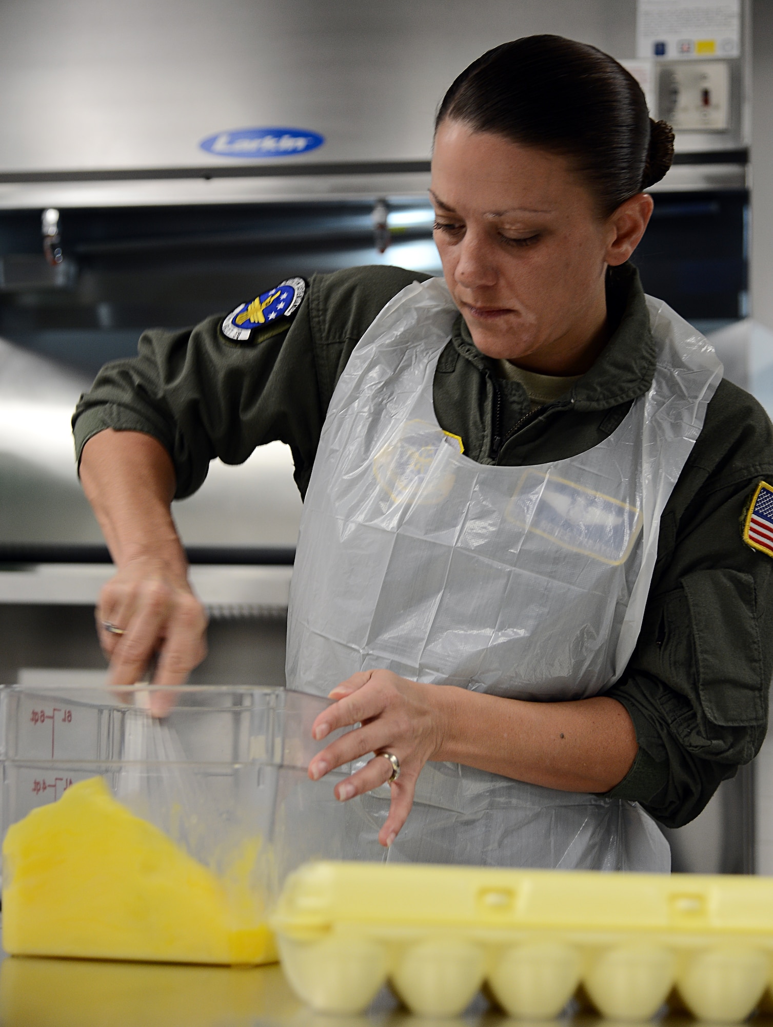 Tech. Sgt. Renee Strayer, 310th Airlift Squadron flight attendant, beats eggs to use in breakfast burritos at MacDill Air Force Base, Fla., Oct. 01, 2013. Strayer made the burritos with sausage, eggs, potatoes and cheese. (U.S. Air Force photo by Airman 1st Class Tori Schultz/Released) 