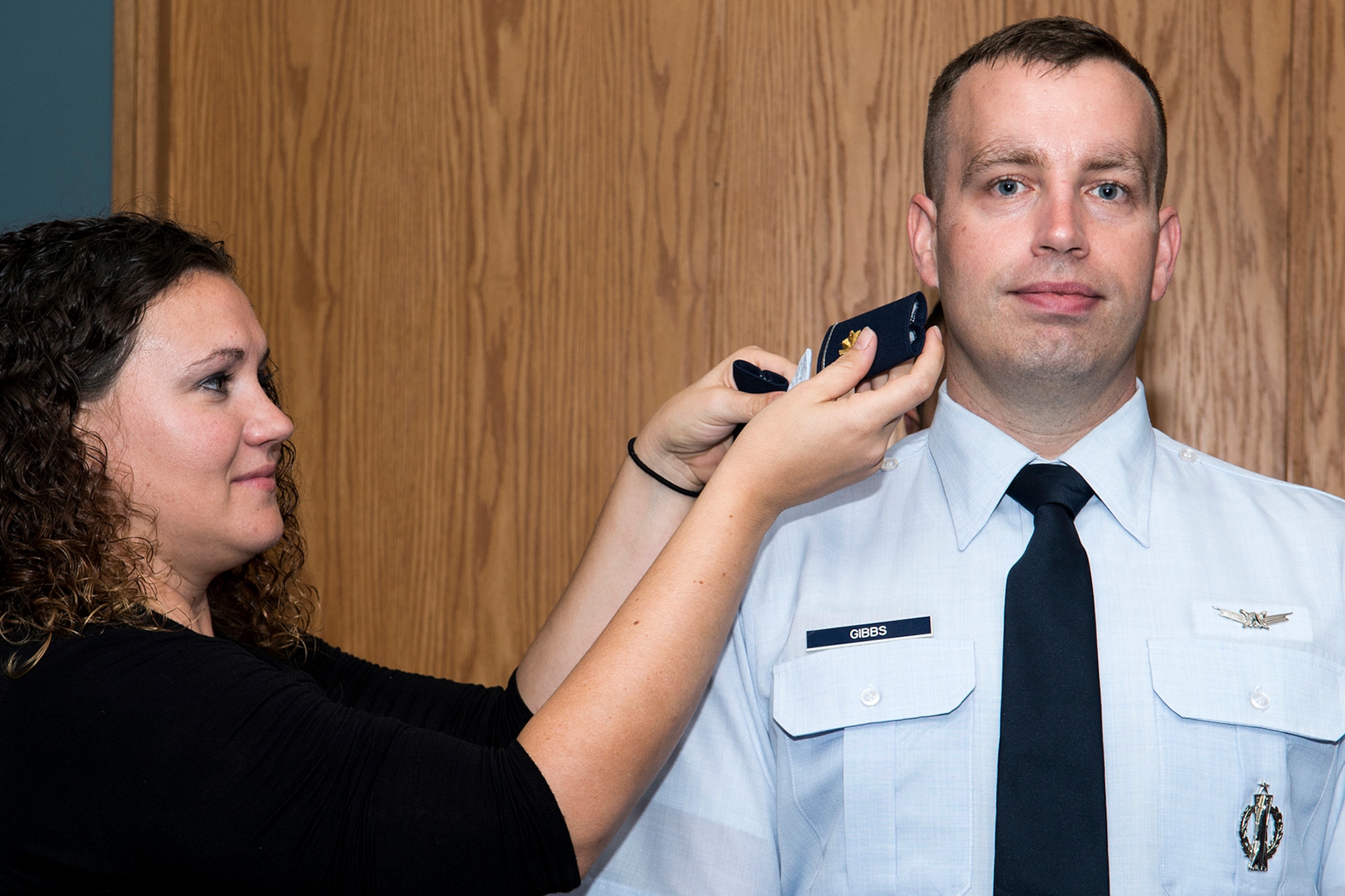 Bekah Gibbs changes her husband’s rank to Major during a Pinning On ceremony, Oct. 5, 2013, Barksdale Air Force Base, La. Bekah is married to U.S. Air Force Maj. Keith Gibbs, who is assigned to the 307th Bomb Wing Command Post. (U.S. Air Force photo by Master Sgt. Greg Steele/Released)