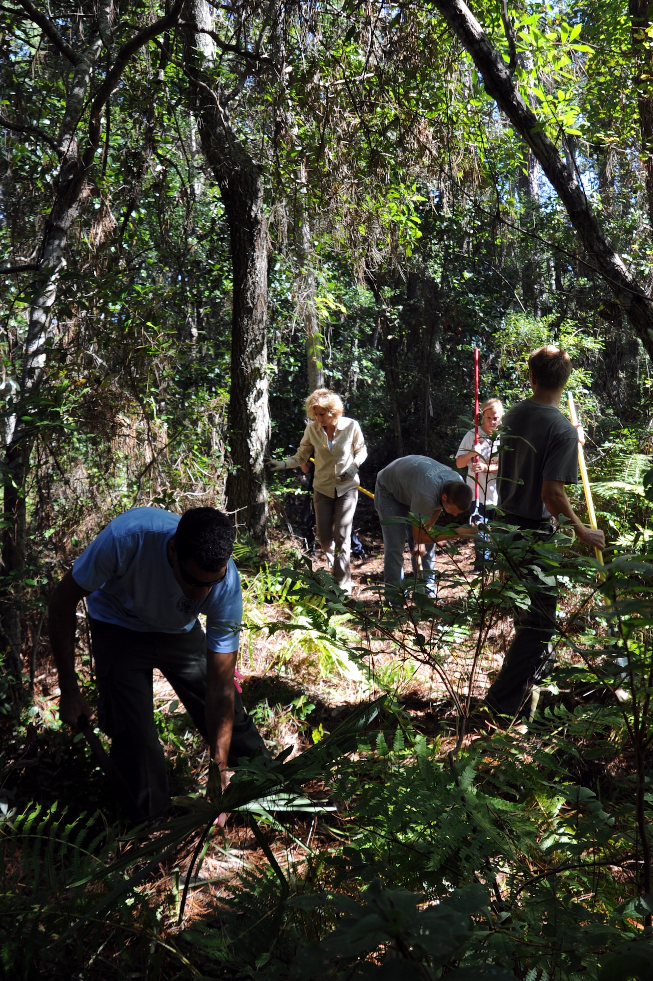 Members from Boy Scout Troop 509, Corvias Military Living and the 1st Special Operations Civil Engineer Squadron, clear brush and debris to make way for a new section of path on the Grace Brown Nature Trail on the Soundside at Hurlburt Field, FL Sept 28, 2013. Rerouting of the trail is the first of four projects started on National Public Lands Day. (U.S. Air Force photo/Staff Sgt. Victoria Sneed)