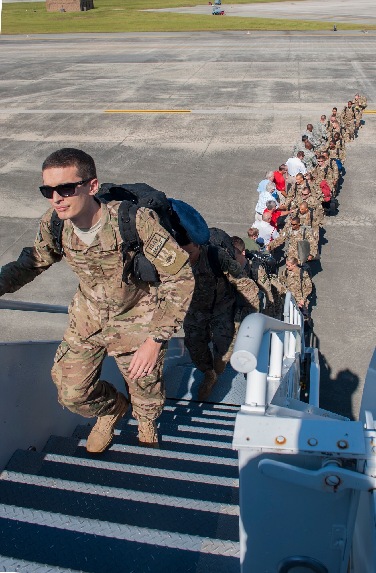 Airmen form a line as base leadership wishes them luck before boarding an aircraft for deployment at Moody Air Force Base, Ga., Sept. 27, 2013. The Airmen who deployed will be deployed for approximately  six months. (U.S. Air Force photo by Airman Alexis Grotz/Released)