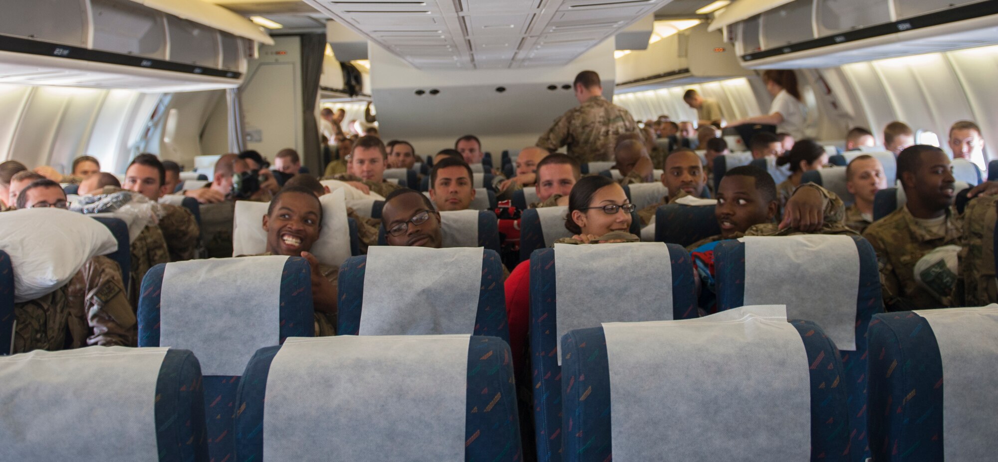 Hundreds of Airmen sit and wait before departing from Moody Air Force Base, Ga., Sept. 27, 2013. Airmen will fly a total of 18 hours before reaching their destination. (U.S. Air Force photo by Airman Alexis Grotz/Released)