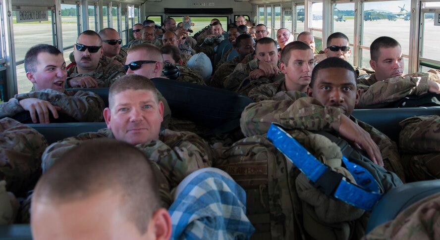 Airmen sit on buses and wait to board an aircraft for deployment at Moody Air Force Base, Ga., Sept. 27, 2013. A total of 285 Airmen deployed to Southwest Asia from Moody. (U.S. Air Force photo by Airman Alexis Grotz/Released)