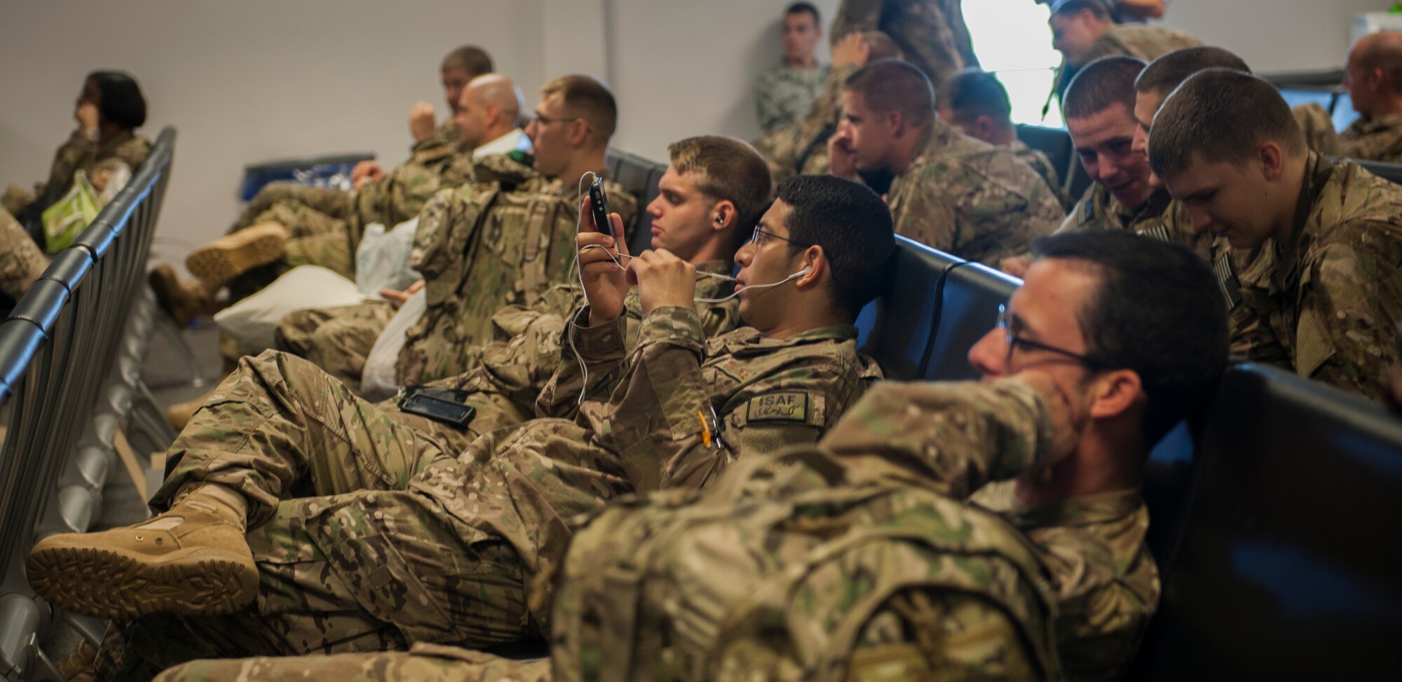 Airmen wait at the deployment control center at Moody Air Force Base, Ga., Sept. 27, 2013. The DCC does a security check to ensure the Airmen stay safe throughout their flight. (U.S. Air Force photo by Airman Alexis Grotz/Released)