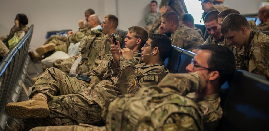 Airmen wait at the deployment control center at Moody Air Force Base, Ga., Sept. 27, 2013. The DCC does a security check to ensure the Airmen stay safe throughout their flight. (U.S. Air Force photo by Airman Alexis Grotz/Released)