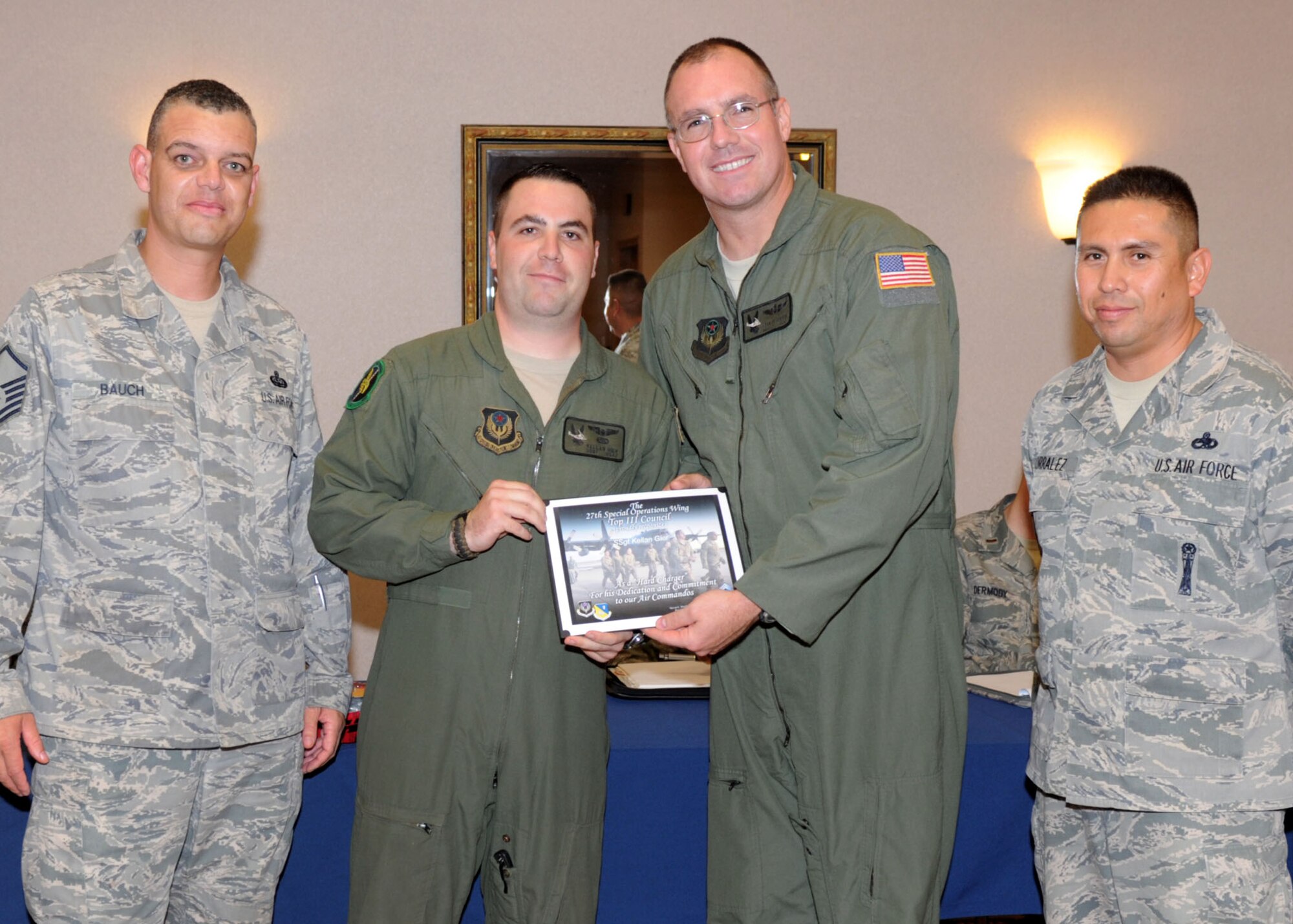 U.S. Air Force Staff Sgt. Kellan Gier, 20th Special Operations Squadron flight engineer receives the Hard Charger award Sept. 27, 2013 at Cannon Air Force Base, N.M. Gier received the award for his stellar performance during increased responsibility, his on the job knowledge, and his williness to go the extra mile. (U.S. Air Force photo/Senior Airman Ericka Engblom)