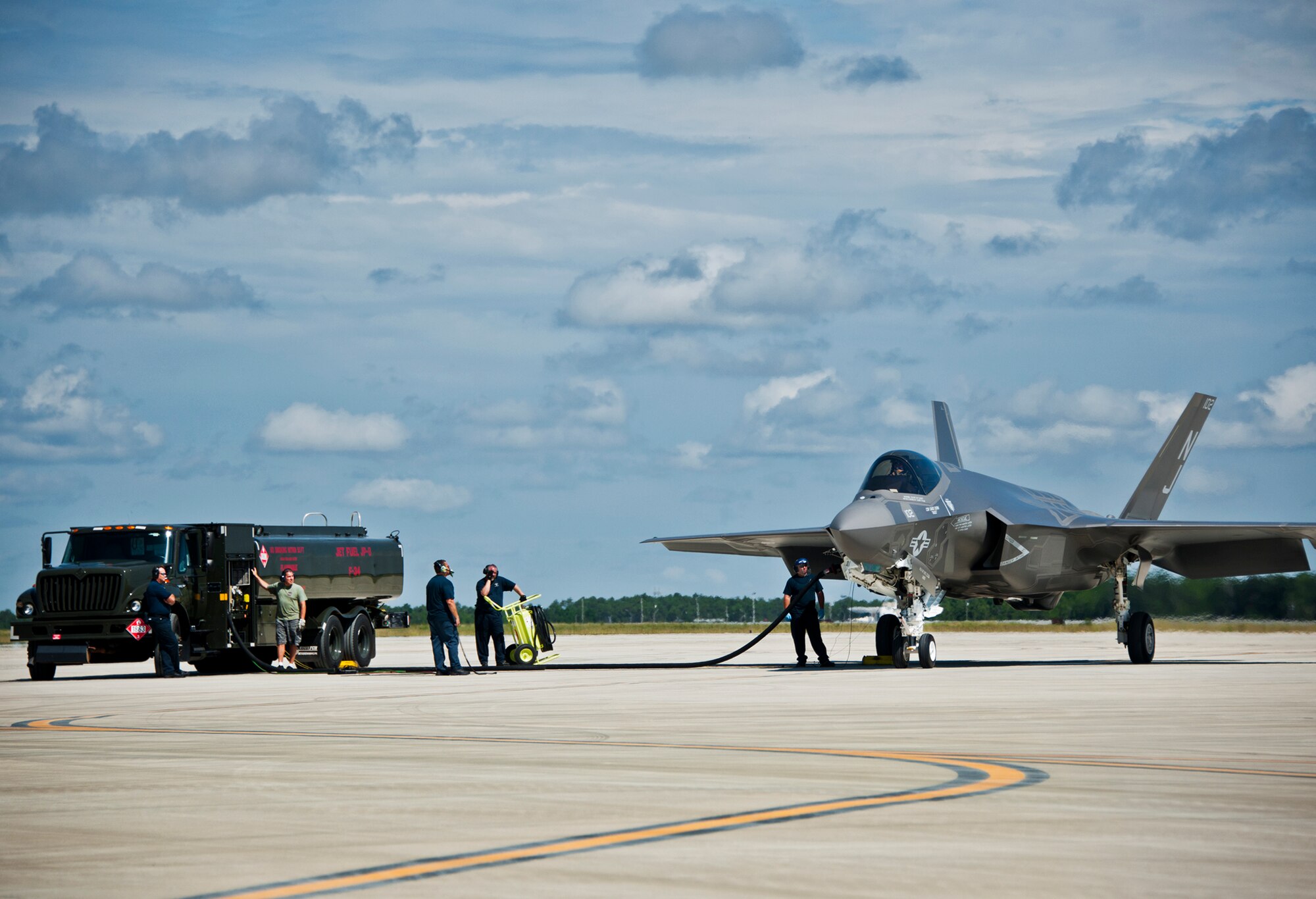 Sailors from the Strike Fighter Squadron-101, refuel an F-35C Lightning II during a hot pit session on the 33rd Fighter Wing flightline at Eglin Air Force Base, Fla.  Airmen, Marines and Sailors are refueling their F-35 variants for multiple sorties via 96th Test Wing fuel trucks while construction is completed on the 33rd’s hot pit area.  (U.S. Air Force photo/Samuel King Jr.)