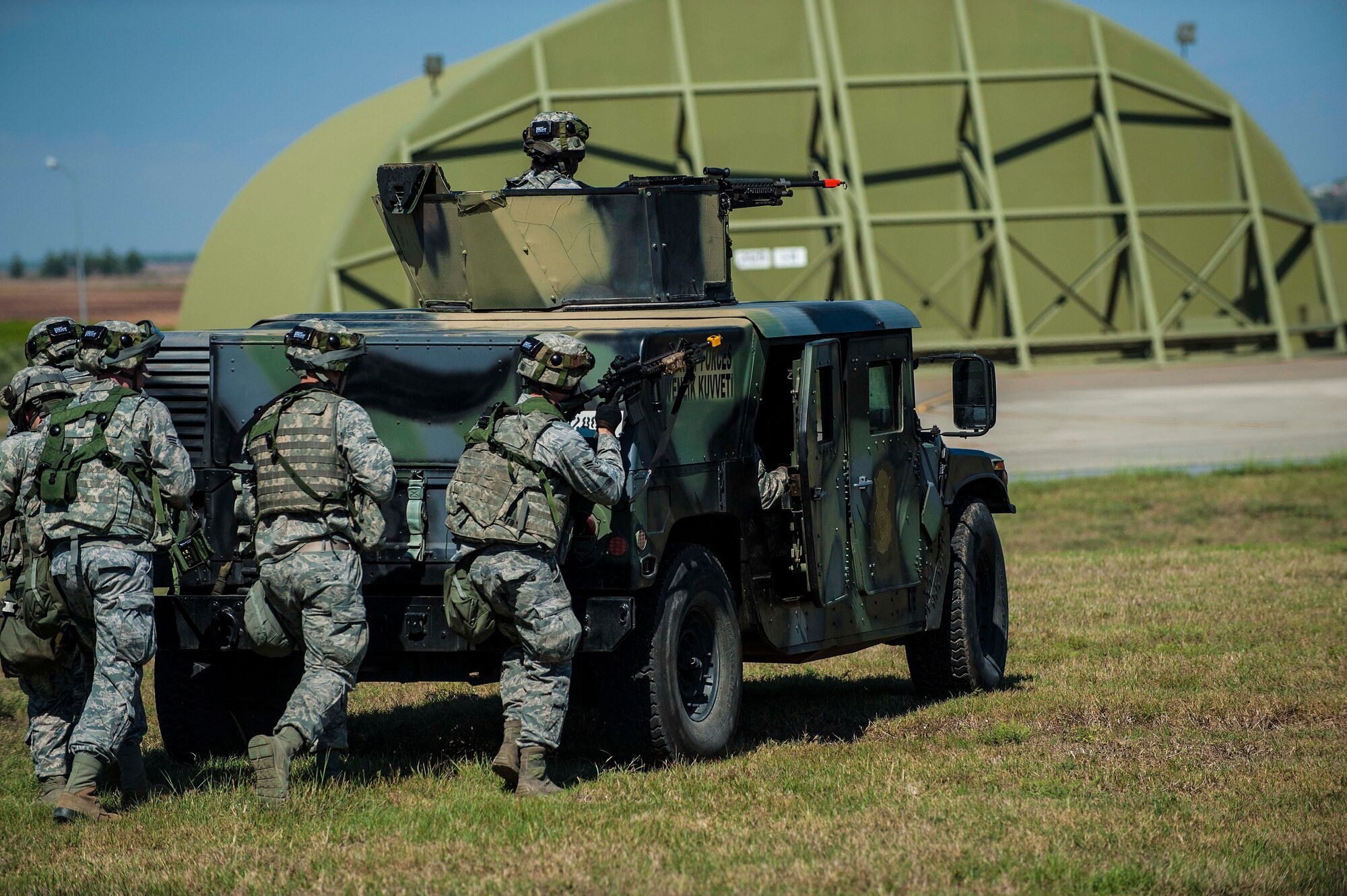 Airmen assigned to the 39th Security Forces Squadron move with cover from behind a Humvee during a force-on-force training exercise Sept. 25, 2013, at Inicirlik Air Base, Turkey. The 39th SFS, along with other security forces Airmen across the Air Force, participate in multiple training exercises throughout year to ensure preparedness for real-world scenarios and mission readiness.  (U.S. Air Force photo by Airman 1st Class Nicole Sikorski/Released) 