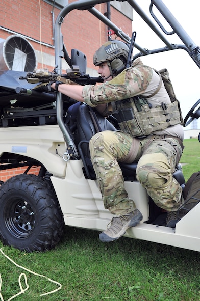 U.S. Air Force Senior Airman Barry Creel, 321st Special Tactics Squadron pararescueman, simulates returning fire on the enemy Oct. 2, 2013, on RAF Mildenhall, England, during a confined-space extraction exercise. Air Force pararescuemen are the only Department of Defense elite combat forces specifically organized, trained, equipped and postured to conduct full-spectrum Personnel Recovery (PR) to include both conventional and unconventional combat rescue operations. These Battlefield Airmen are the most highly-trained and versatile PR specialists in the world. (U.S. Air Force photo by Airman 1st Class Kyla Gifford/Released)