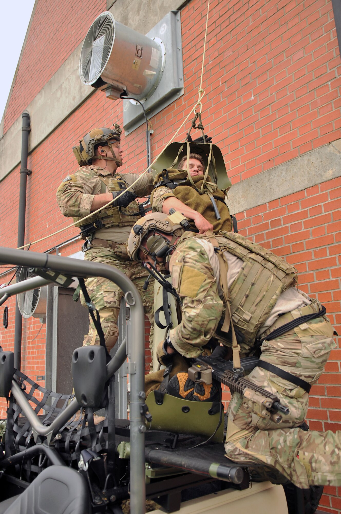 U.S. Air Force pararescuemen from the 321st Special Tactics Squadron assist in the recovery of “wounded” personnel Oct. 2, 2013, on RAF Mildenhall, England, during a confined-space extraction exercise.  Airmen from the 321st STS routinely train on different scenarios in order to stay certified and prepared to execute any mission necessary. Pararescuemen are the most highly-trained and versatile Personnel Recovery specialists in the world, and will do whatever is required to deny the enemy a victory and bring our warriors home to fight another day. (U.S. Air Force photo by Airman 1st Class Kyla Gifford/Released)