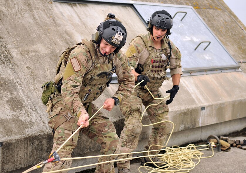 U.S. Air Force Staff Sgt. Matthew Blankenship, left, and Staff Sgt. Trevor Clark, 321st Special Tactics Squadron pararescuemen, work together to hoist a fellow pararescueman up to the roof of a building Oct. 2, 2013, on RAF Mildenhall, England. To successfully execute the mission, pararescuemen must work together and use each other’s strengths. Pararescue is the nation's force of choice to execute the most perilous, demanding and extreme rescue missions anytime, anywhere across the globe. Airmen from the 321st STS routinely train on different scenarios in order to stay certified and prepared to execute any mission necessary. (U.S. Air Force photo by Airman 1st Class Kyla Gifford/Released)