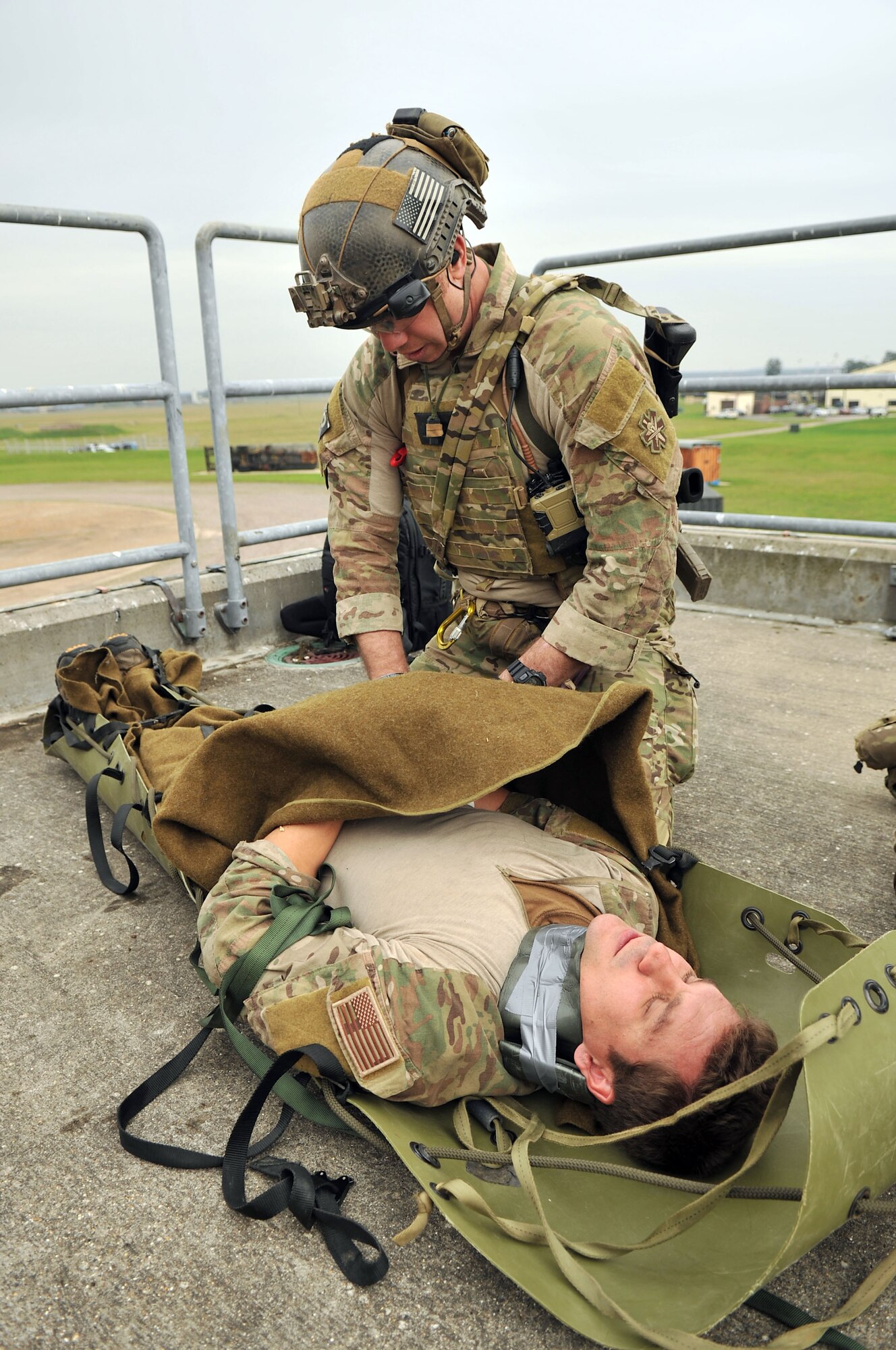 A U.S. Air Force 321st Special Tactics Squadron pararescueman performs medical treatment on “wounded” personnel Oct. 2, 2013, on RAF Mildenhall, England, during a confined-space extraction exercise. All pararescuemen are qualified paramedics and experts in battlefield trauma. Airmen from the 321st STS routinely train on different scenarios in order to stay certified and prepared to execute any mission necessary. (U.S. Air Force photo by Airman 1st Class Kyla Gifford/Released)