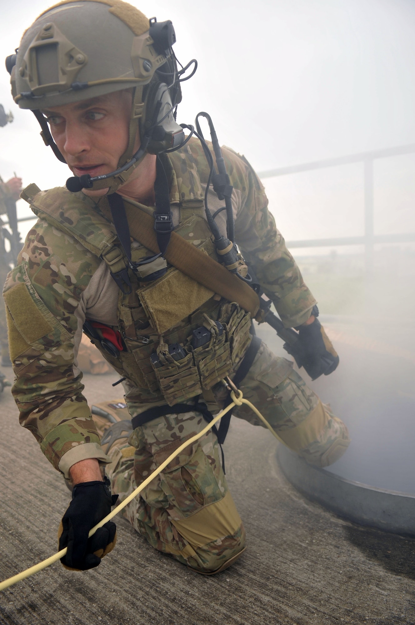 U.S Air Force Staff Sgt. Seth Lawrence, 321st Special Tactics Squadron pararescueman, prepares to descend into a metal tube Oct. 2, 2013, on RAF Mildenhall, England. Lawrence performed his portion of the pre-planned mission protocol, assisting in the recovery of “wounded” personnel. Pararescuemen trained to successfully negotiate an extraction of wounded personnel as part of a confined-space extraction exercise. (U.S. Air Force photo by Airman 1st Class Kyla Gifford/Released)