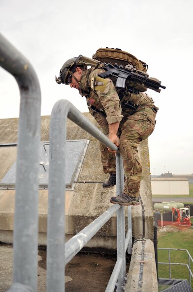 U.S. Air Force Senior Airman Jared Isenhart, 321st Special Tactics Squadron pararescueman, climbs onto the roof of a building Oct. 2, 2013, on RAF Mildenhall, England, during a confined-space extraction exercise. Isenhart performed his portion of the pre-planned mission protocol, assisting in the recovery of “wounded” personnel. Air Force pararescuemen, also known as PJs, are the only Department of Defense elite combat forces specifically organized, trained, equipped and postured to conduct full-spectrum Personnel Recovery (PR) to include both conventional and unconventional combat rescue operations. (U.S. Air Force photo by Airman 1st Class Kyla Gifford/Released)