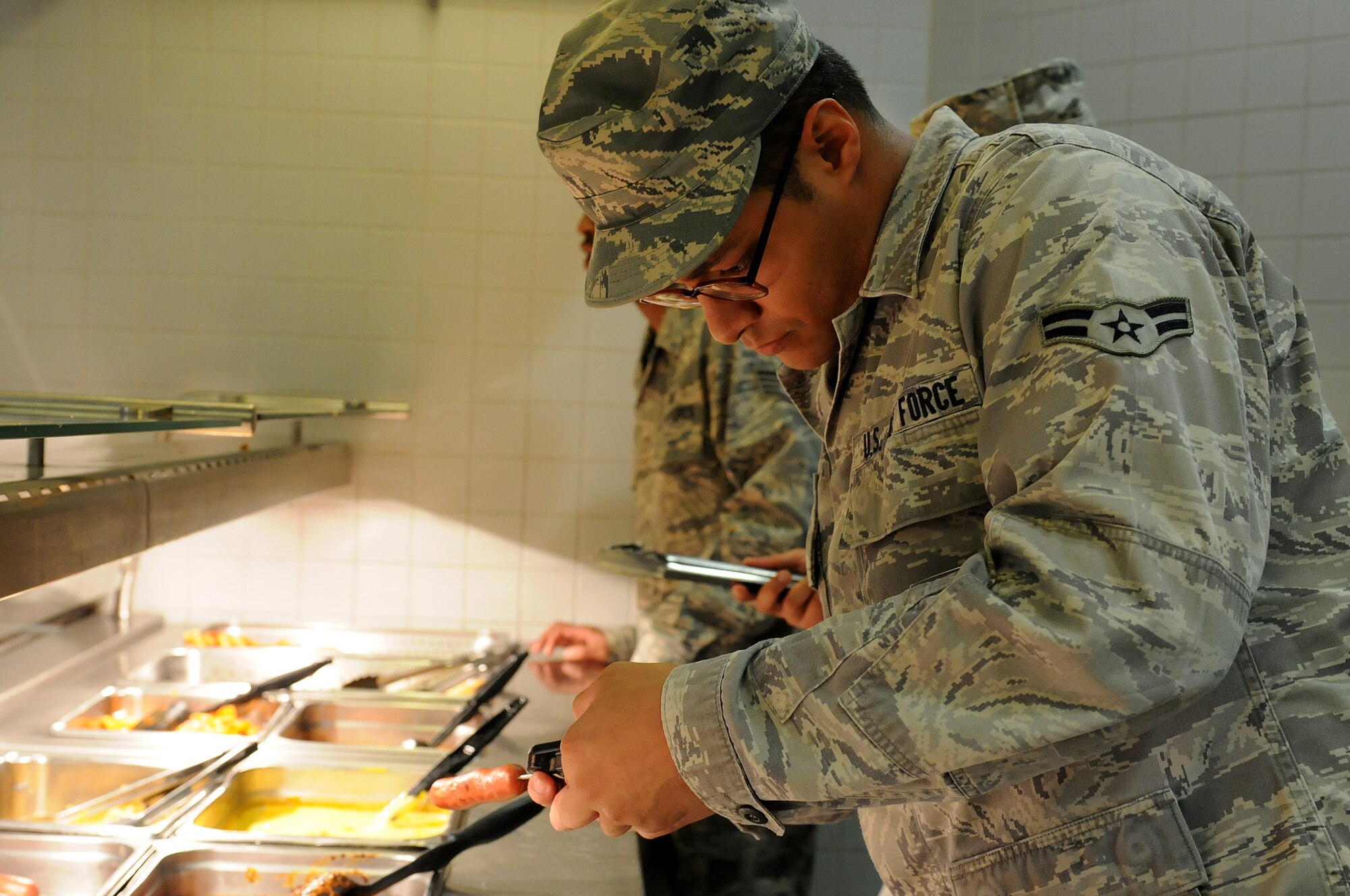 Airman 1st Class Christopher Blount, 86th Medical Group public health technician, takes the temperature of food on the serving line at the Rhineland Inn dining facility to make sure it has been cooked properly, Oct. 1, 2013, Ramstein Air Base, Germany. Members of the food safety and sanitation office help ensure military members and their families are eating food that is made properly in clean and safe facilities. (U.S. Air Force photo/Airman 1st Class Holly Mansfield)