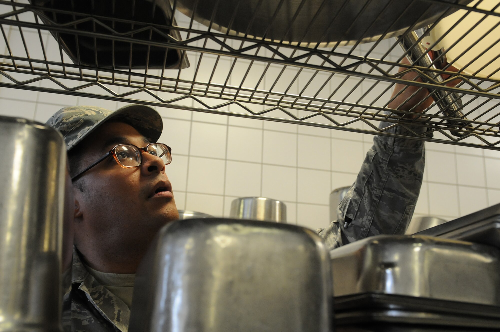 Airman 1st Class Christopher Blount, 86th Medical Group public health technician, inspects pots, pans and cooking appliances to ensure they are clean before and after usage, Oct. 1, 2013, Ramstein Air Base, Germany. Members of the food safety and sanitation office help ensure military members and their families are eating food that is made properly in clean and safe facilities. (U.S. Air Force photo/Airman 1st Class Holly Mansfield)