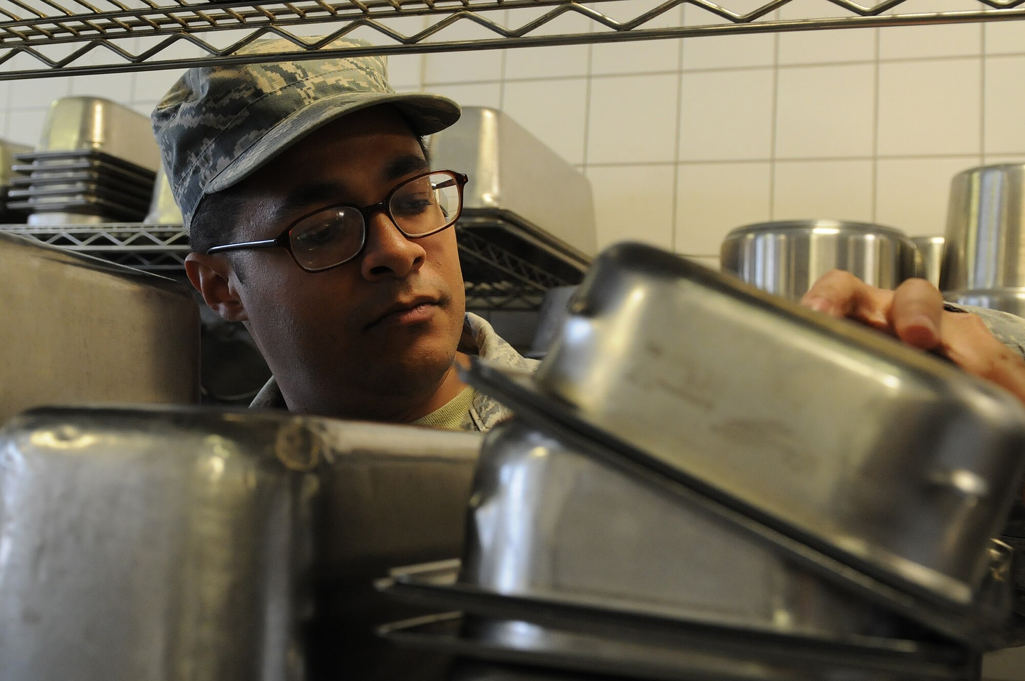 Airman 1st Class Christopher Blount, 86th Medical Group public health technician, inspects pots, pans and cooking appliances to ensure they are clean before and after usage, Oct. 1, 2013, Ramstein Air Base, Germany. Members of the food safety and sanitation office help ensure military members and their families are eating food that is made properly in clean and safe facilities. (U.S. Air Force photo/Airman 1st Class Holly Mansfield)