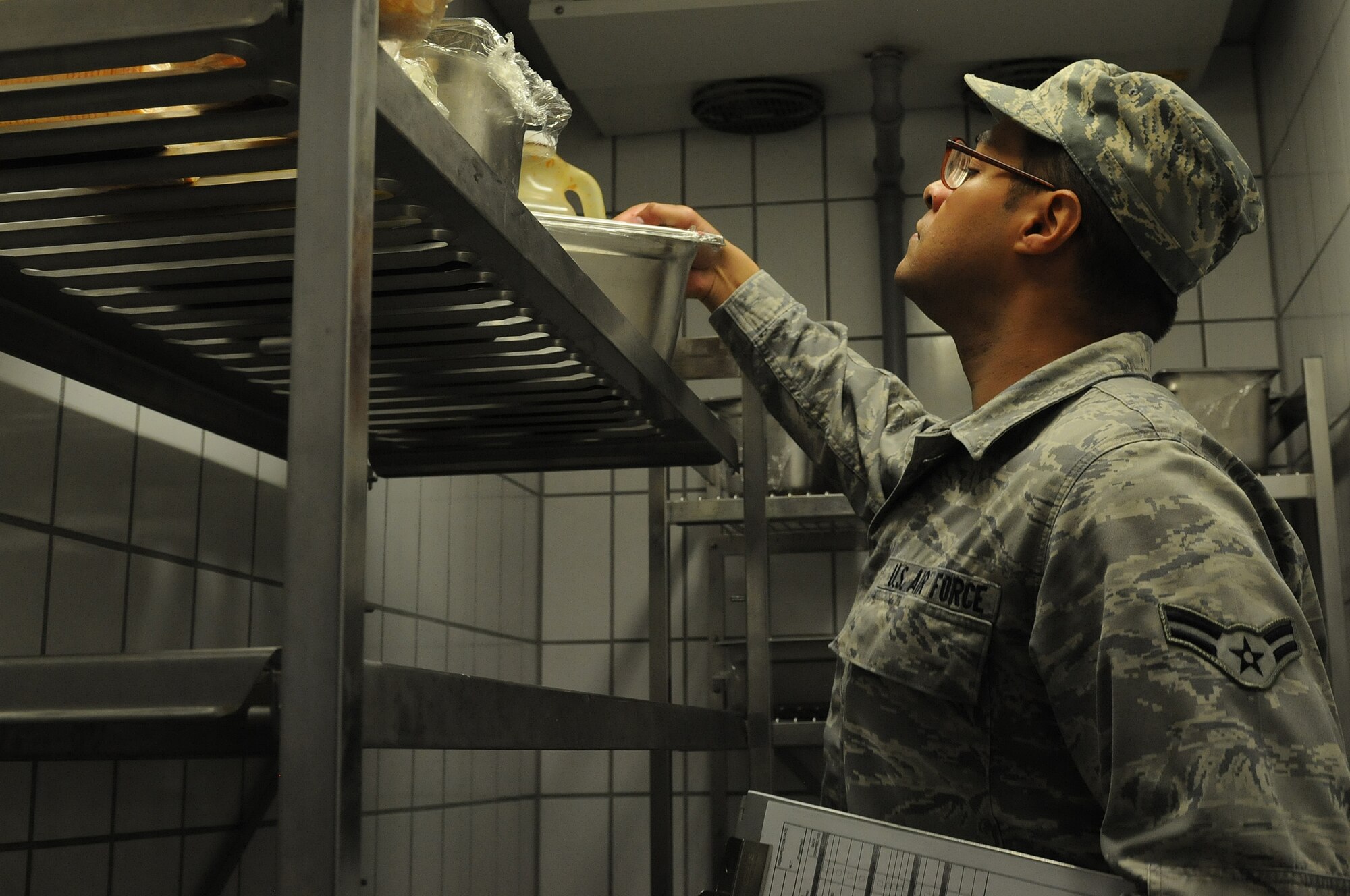Airman 1st Class Christopher Blount, 86th Medical Group public health technician, inspects pots, pans and cooking appliances to ensure they are clean before and after usage, Oct. 1, 2013, Ramstein Air Base, Germany. Members of the food safety and sanitation office help ensure military members and their families are eating food that is made properly in clean and safe facilities. (U.S. Air Force photo/Airman 1st Class Holly Mansfield)