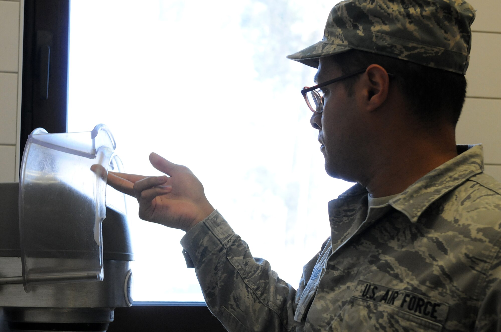 Airman 1st Class Christopher Blount, 86th Medical Group public health technician, inspects pots, pans and cooking appliances to ensure they are clean before and after usage, Oct. 1, 2013, Ramstein Air Base, Germany. Members of the food safety and sanitation office help ensure military members and their families are eating food that is made properly in clean and safe facilities. (U.S. Air Force photo/Airman 1st Class Holly Mansfield)