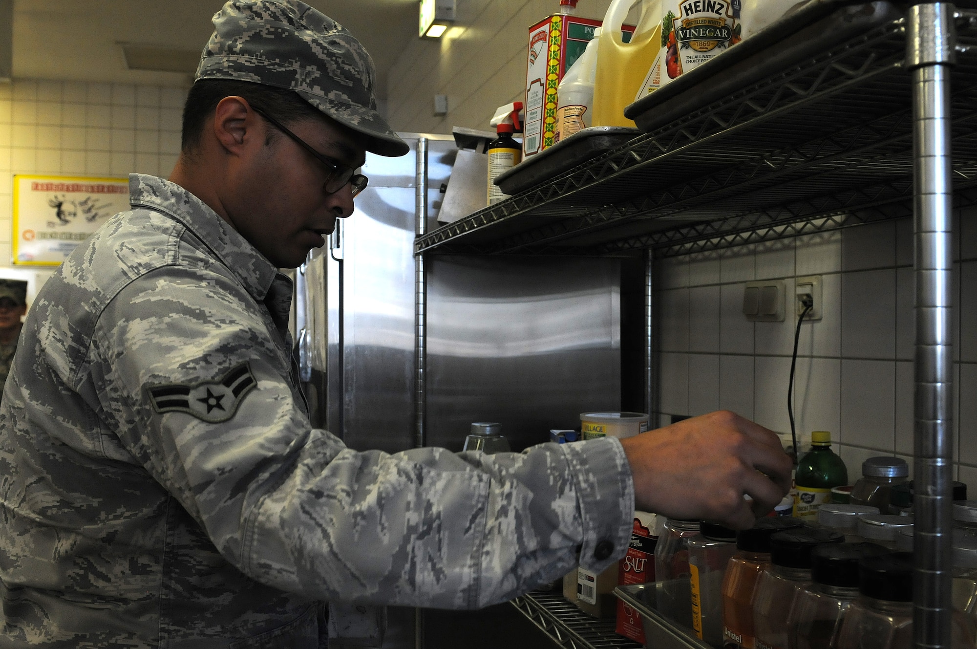 Airman 1st Class Christopher Blount, 86th Medical Group public health technician, inspects spices at the dining facility to ensure it is properly stored, Oct. 1, 2013, Ramstein Air Base, Germany. Members of the food safety and sanitation office help ensure military members and their families are eating properly made food in clean and safe facilities. (U.S. Air Force photo/Airman 1st Class Holly Mansfield)