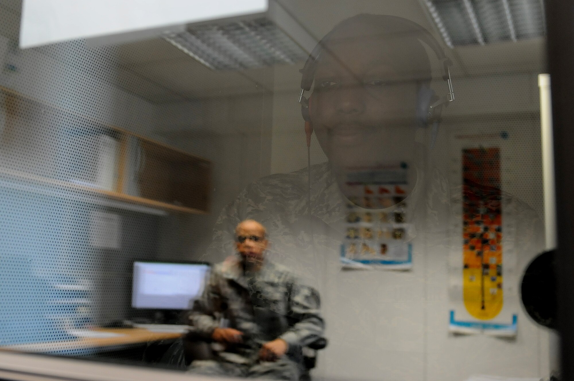 Staff Sgt. Alton Mercy, 86th Medical Group public health technician, receives information on how to administer a hearing test from Airman 1st Class Allen Cherry, 86th MDG public health technician, in order to check if a patient’s hearing has changed, Oct. 1, 2013, Ramstein Air Base, Germany. The occupational health office offers hearing tests for military members who work in industrial hazard environments to ensure their hearing is at the right level to accomplish the mission. (U.S. Air Force photo/Airman 1st Class Holly Mansfield)